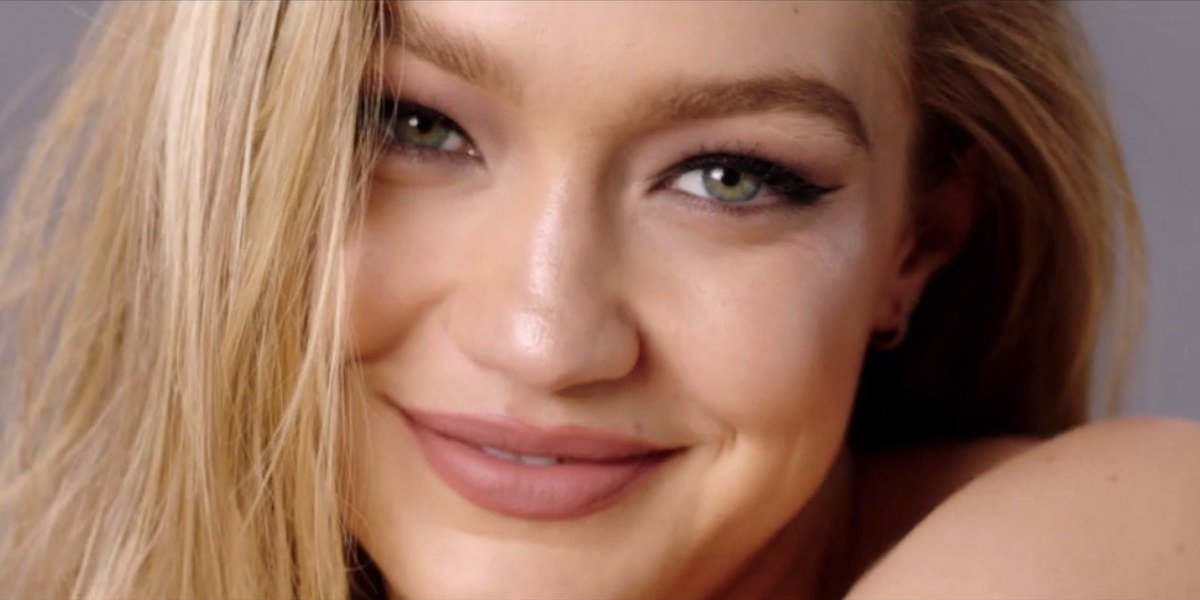 Gigi Hadid smiling during a Maybelline beauty campaign shoot